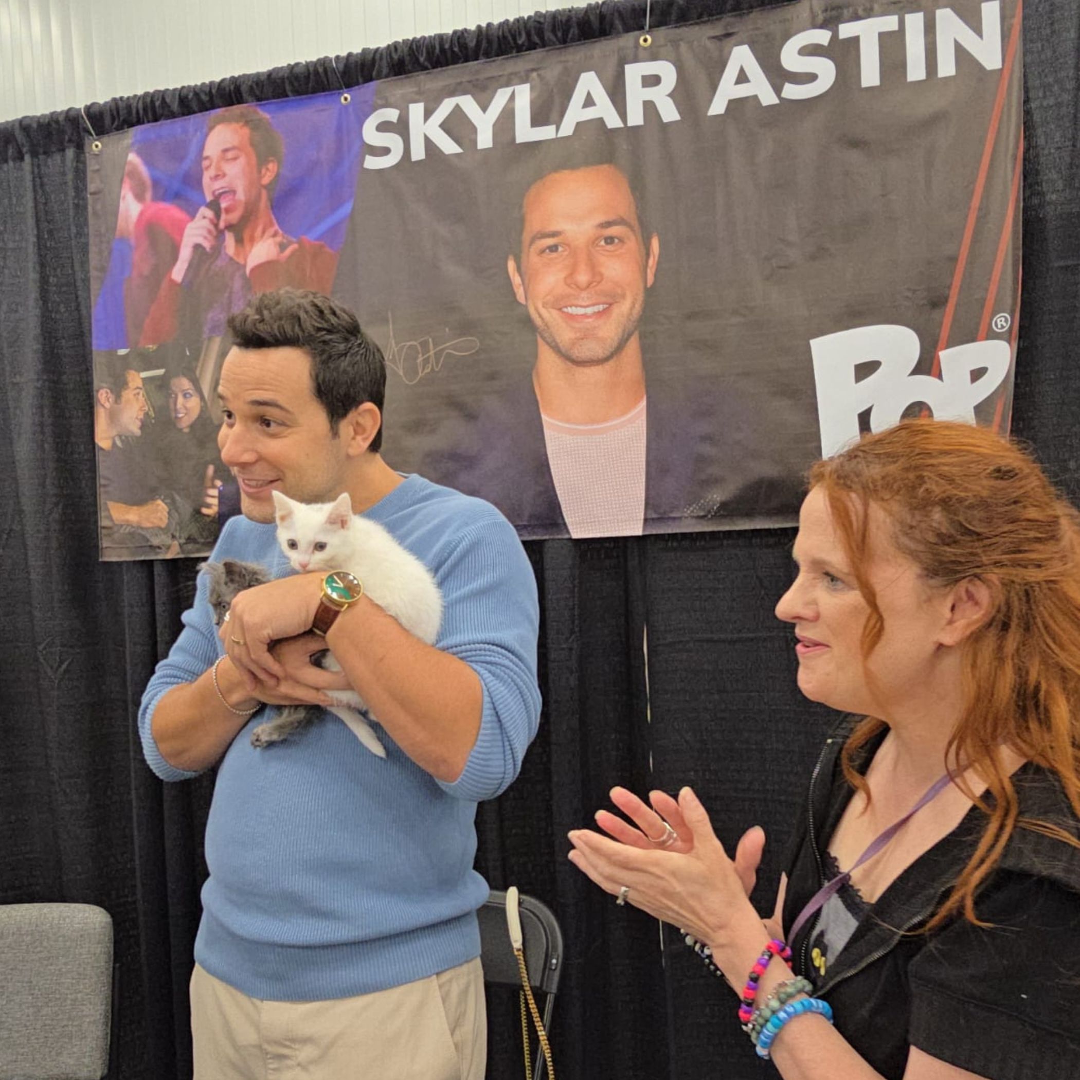 Celebrity guest holding a kitten at PurrCon